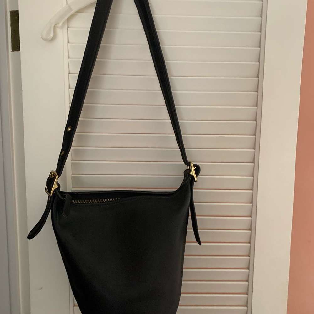 Coach bucket purse with brass buckles, long adjustable strap. It is Pristine!